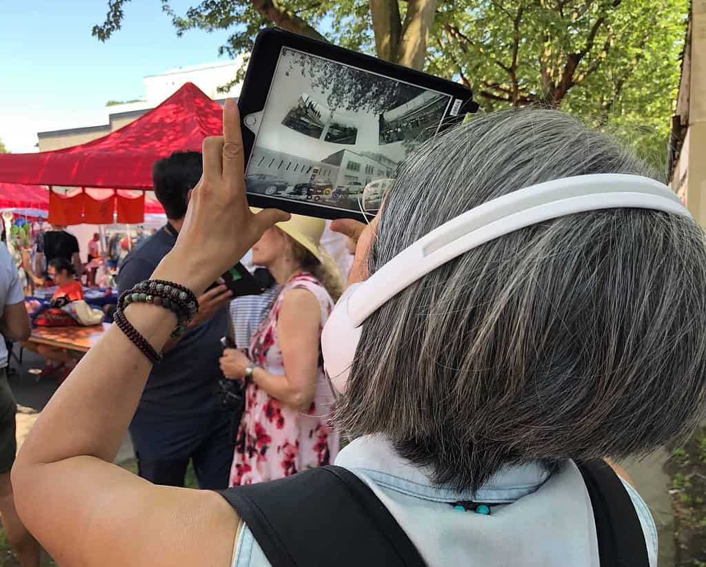 Woman using 360 Riot Walk Interactive 360 Video Technology on a tablet up close.