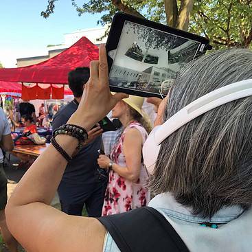 Woman using 360 Riot Walk Interactive 360 Video Technology on a tablet up close.
