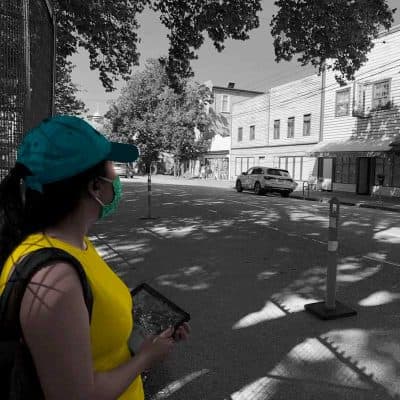 Colourized black-and-white photo of a female looking at buildings on Powell Street